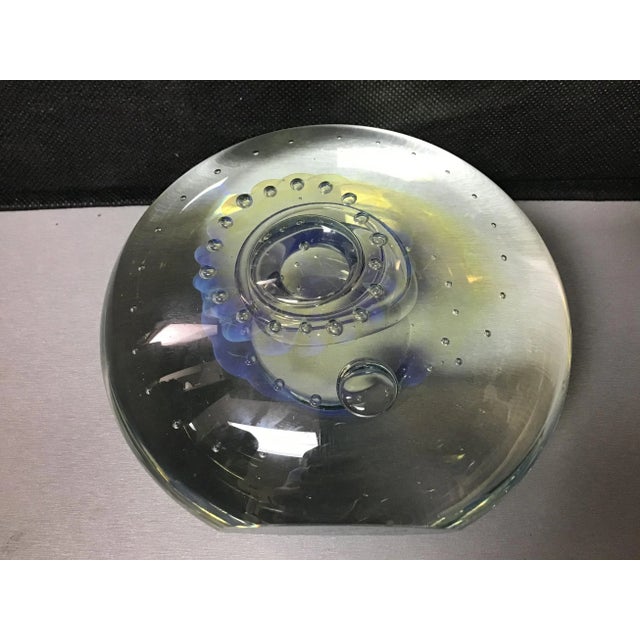 Signed art glass paperweight by renowned Ohio glass blower / artist, Robert Eickholt. Round clear form with an interior...