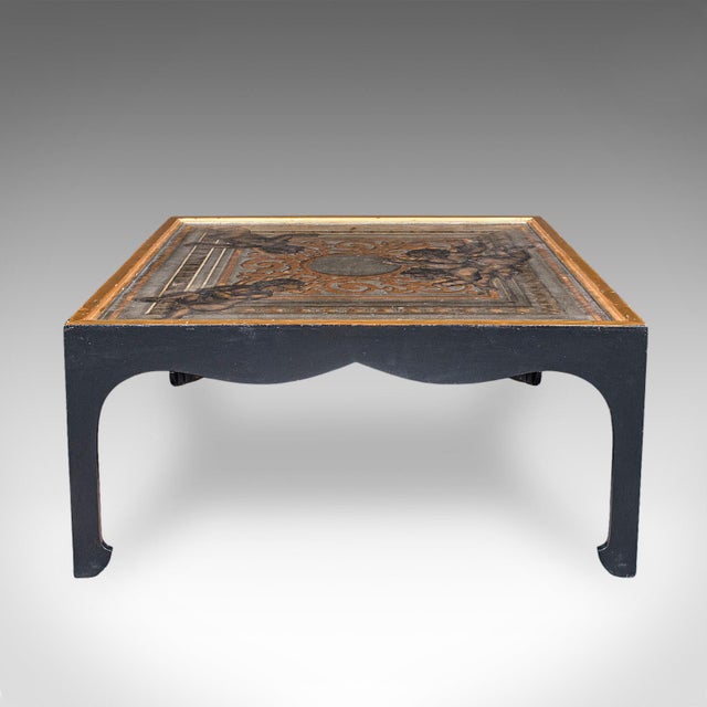 This is a vintage Chinoiserie coffee table. An Italian, gilt and ebonised pine accent table with handpainted top, dating...