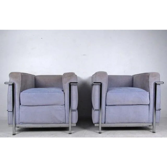 This matching vintage pair of stuffed lounge chairs feature the interlocking cushion design made widely popular in the...