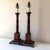 Vintage pair of colonial style turned mahogany lamps with bronze bases. The pair are in a dark warm walnut and solid. The...