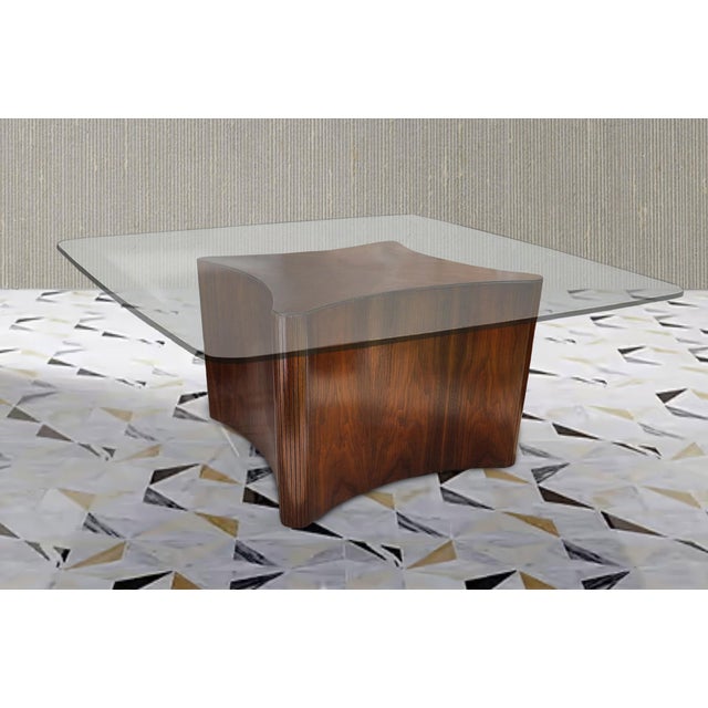 Thick walnut veneer is scored to wrap corners of a heavy biomorphic wood frame. The top is pieced with four sections of...