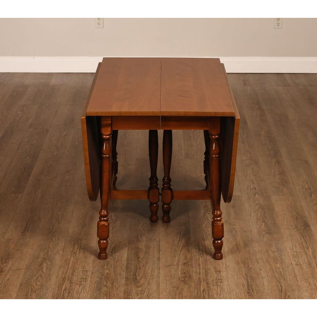 High Quality American Made Vintage Traditional Maple Drop Leaf Gateleg Dining Table. Features a Rectangular Top With Two...
