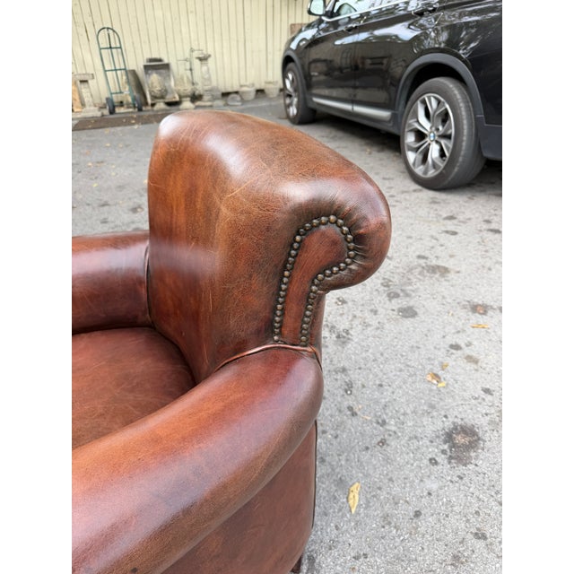 This is a lovely pair of English leather club chairs. With rounded backs and rolled arms, these chairs offer exceptional...