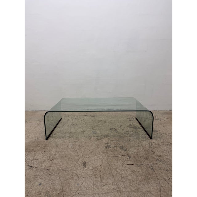 Etched clear tempered postmodern glass waterfall coffee or cocktail table with black painted wood floor protectors...