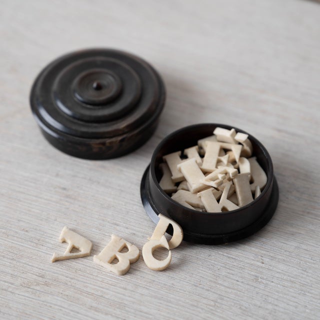 A complete set of Victorian bovine bone alphabet letters in a turned bovine horn box with fitted lid, circa 1840. 2 ¼...