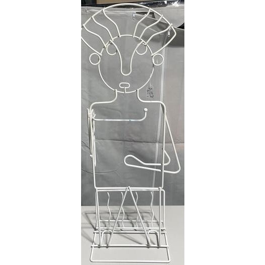 A whimsical vintage magazine holder by John Risley, featuring a standing human figure formed from sculptural metal wire....
