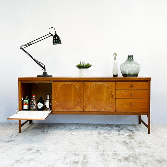 Teak Nathan Circles sideboard featuring the distinctive circular door panel mouldings and tapered legs with lower...