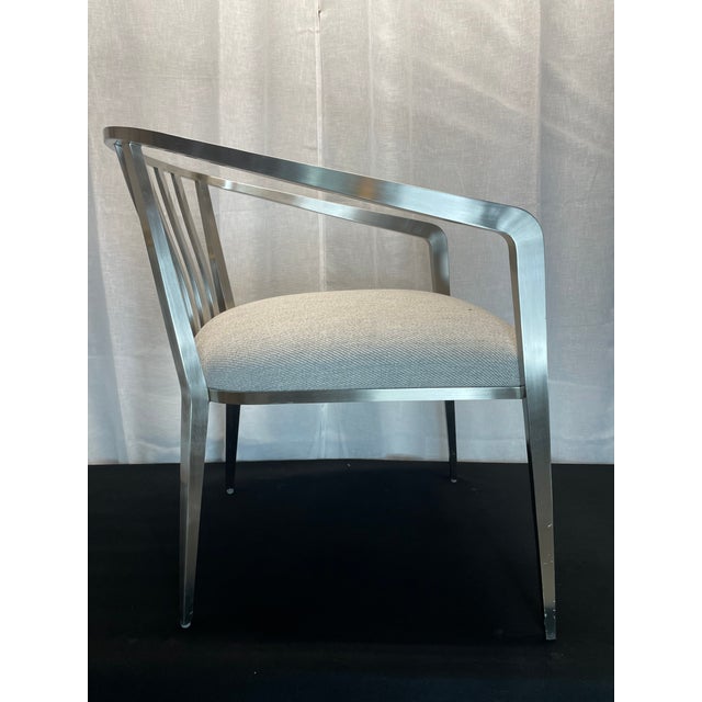 This sleek dining or accent chair by Caracole is offered in a modern silver finish with a creamy grey seat cover. The...