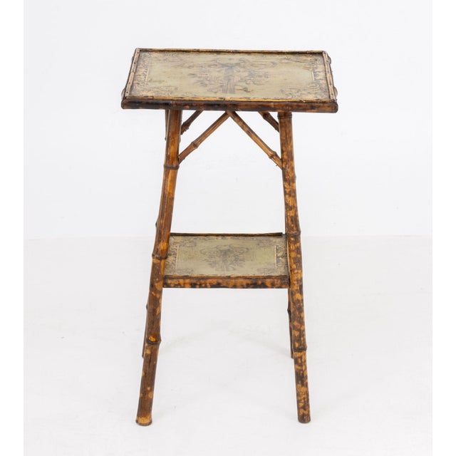 Aesthetic Movement Bamboo Two-Tier Side Table, with green painted decoupage tops. 25.5" H x 15.25" W x 15.5" D....