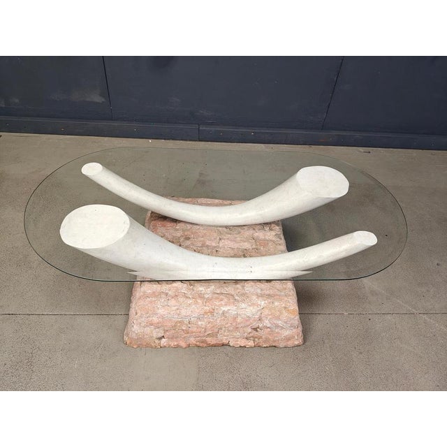 Striking vintage faux tusk coffee table made from tesselated stone with a beveled clear oval glass top. Beautiful and...