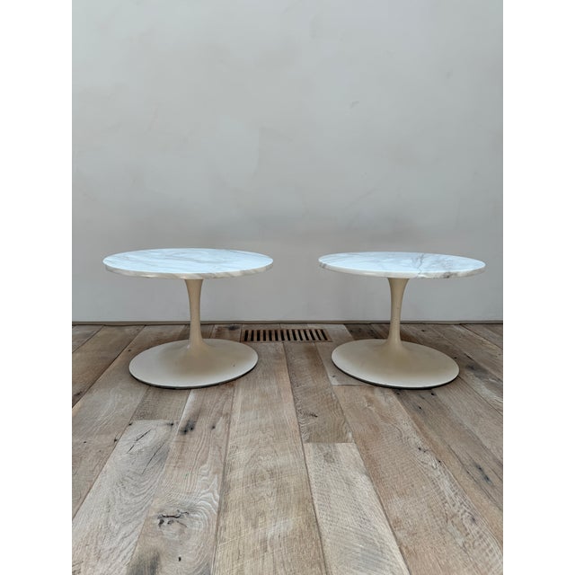 An early pair of seerinen marble top side tables. Tops are in very good condition, bases show more wear and scuffs. Tops...