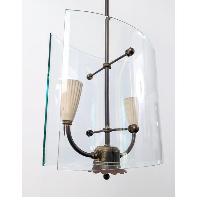 Pietro Chiesa designed this refined pendant lamp of curved glass and brass for Fontana Arte in Italy during the 1940s. The...