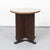 A distinctive Art Deco side table from the 1930s, featuring an elegant solid oak base and a burl-veneered top. An elegant...