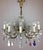 A stunning Maria Theresa 10 arm crystal chandelier fully arranged with colored rock crystals and drops. This antique...