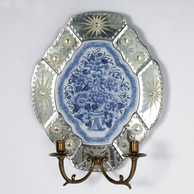 Standout pair of mid century wall sconces featuring blue and white porcelain plaques inside mirrored frames with etched...