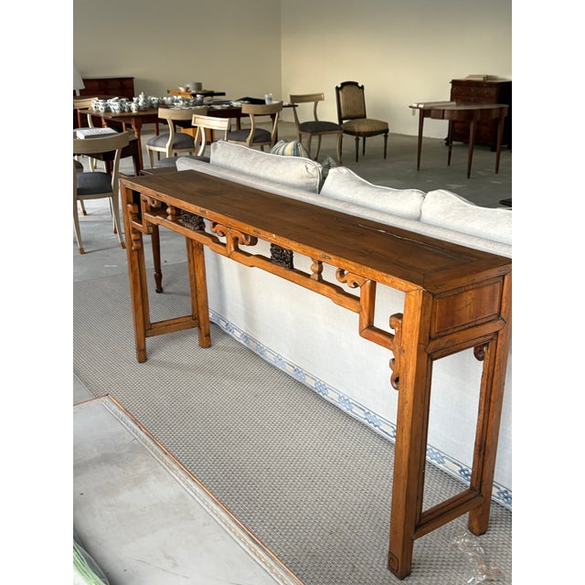 A striking 19th-century Chinese Altar table (Qiaotou'an), handcrafted from solid elmwood (Yumu) with a rich, naturally...