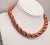 1950s goldtone spiral wrapped faux-coral beaded necklace with hook clasp. Marked "NAPIER" on the hook. Measures: 5 1/4...