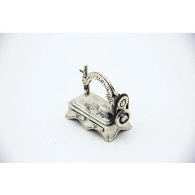 Miniature Silver Sewing Machine, in Very Good conditions. Designed 1980 to 1989 This piece has an attribution mark, I am...