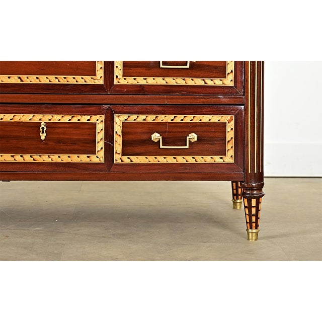 An extraordinary French mahogany commode from the 18th century, Louis XVI Period, decorated with an impressive marquetry...