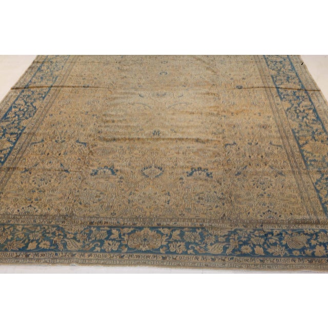 A late 19th century Persian Tabriz carpet, the camel with a subtle allover trellis of flowering vinery, palmettes and...