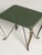 A charming pair of Mid-Century Modern Italian stools, featuring green faux leather upholstery and elegantly sculpted brass...