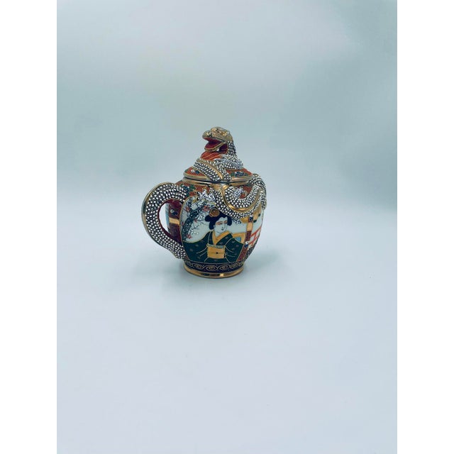 This sugar bowl was produced in Japan between the 1930s and 1950s in the opulent Satsuma, Kutania style, and is made of...