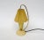 An extraordinary, petite table lamp from the 1950s. The lampshade acts like a lantern. The lampshade is made of linen...