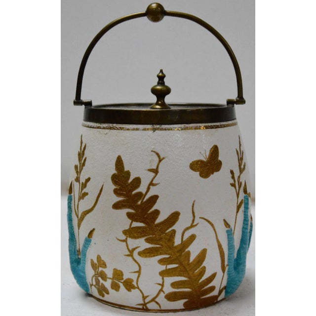 We are offering you a unique biscuit jar featuring raised turquoise Crow claws amongst gold leaves on white porcelain. The...
