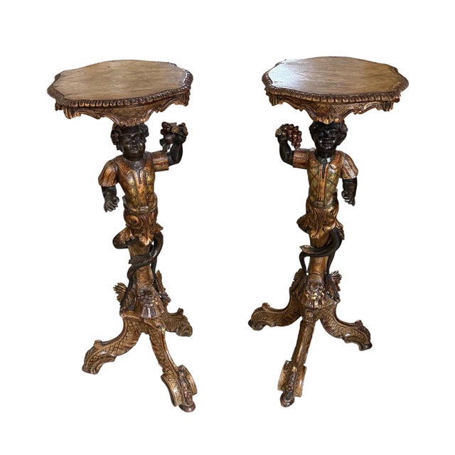 An exceptional pair of mid-19th century Italian carved polychrome and gilt figural pedestal tables, dating to circa 1860...