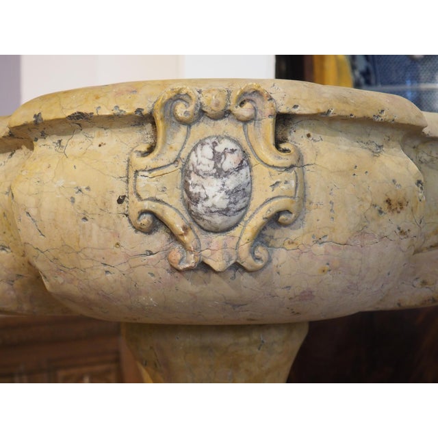 An exquisite Italian holy water vessel, this stoup has been hand carved out of beautiful, old Giallo Reale Rosato marble....