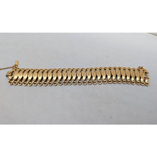 1960s textured goldtone pointed overlapping ellipses with loops at the edges articulated bracelet with fold over clasp and...