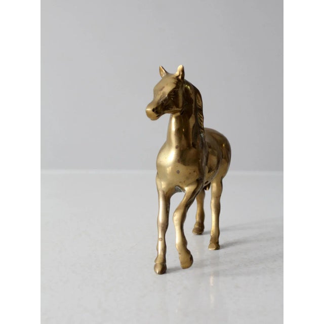 This is a mid-century brass horse figurine. Nice detailing to the equine figure with a lovely age to the brass tone.