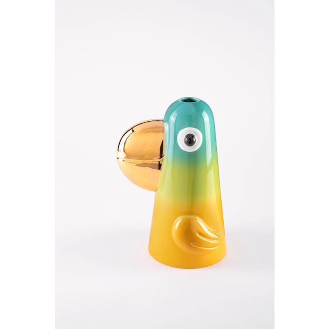 A vase inspired by tropical birds, with prominent beaks and shaded colors similar to candies or lollipop. Similar to a...