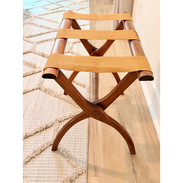 Elegant vintage folding luggage rack or valet stand crafted in richly toned wood with sculptural X-form legs and three...