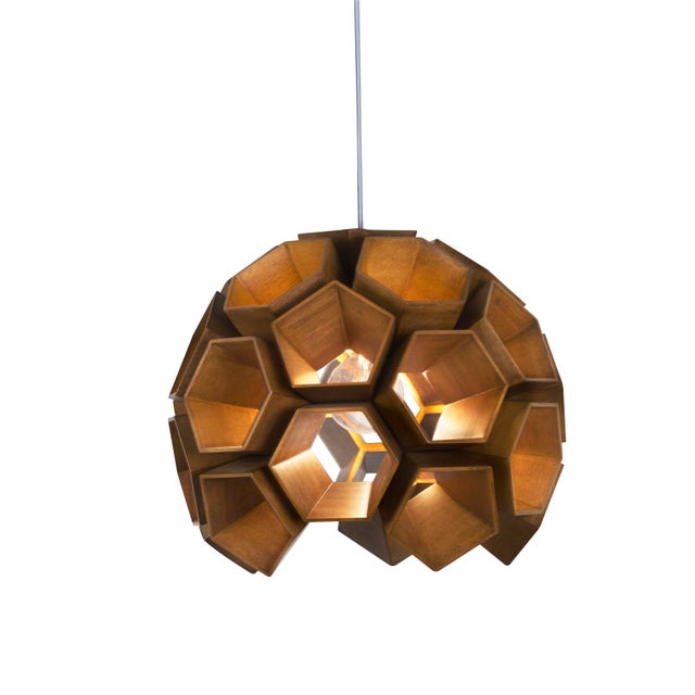 An intricate wood beehive that filters light through a room in the most beguiling way, the Constella pairs a hand-arranged...