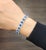 This stunning bracelet showcases 12.40 carats of oval blue Ceylon sapphires, each stone carefully matched for color and...