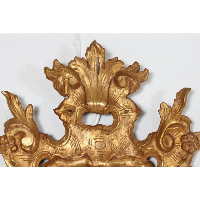 European Rococo mirror made of hand carved giltwood with openwork ornaments and old mirror glass circa 1800. Presumably...