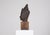 Copper alloy sculpture of a Buddha head, Thailand, 20th century. The Buddha head is presented on a solid wood base. Claude...