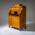 Biedermeier roll-top secretary raised on block-mounted square legs and fitted with three drawers in the lower section....