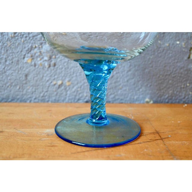 This large blue-foot glass cut was made in a glassware of Empoli in Italy in the 1960s and 70s. In the shape of a glass on...