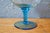 This large blue-foot glass cut was made in a glassware of Empoli in Italy in the 1960s and 70s. In the shape of a glass on...