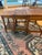 Charming set of three vintage nesting tables crafted in warm-toned. The smallest table includes a lower shelf for...