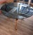 Round table made in the 1950s with a carved brass base and glass top. The actual glass measures 120cm but the base can...