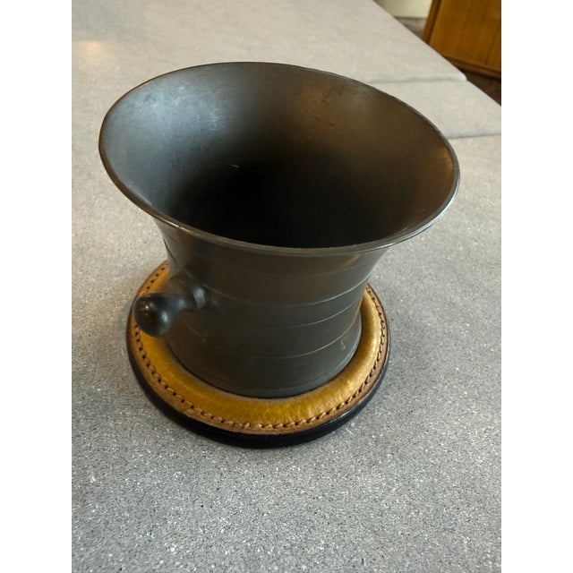 A vintage Gucci desk pen holder crafted in Italy, featuring a sculptural flared pewter vessel with turned side accents...