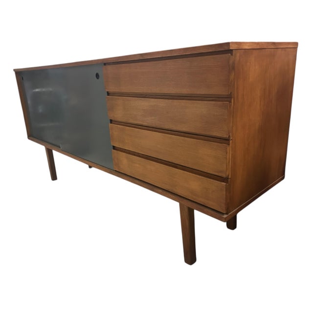 Ash wood sideboard with two sliding gray lacquered doors and four drawers. Designed by Pierre Guariche for A.R.P.,...