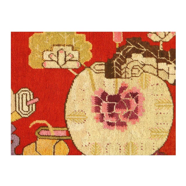 Originating from East Turkestan between 1920-1940, this antique transitional Khotan rug has a medallion-style field design...