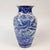 This Blue and white vase has a bird and flower motif that wraps around the entire vase