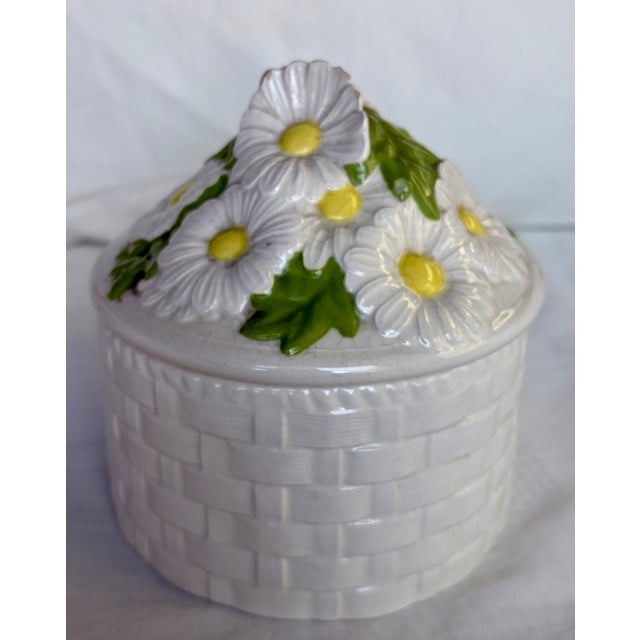 Please, don't eat the daisies! But feel free to use this round basket weave white ceramic jewelry box with dimensional...