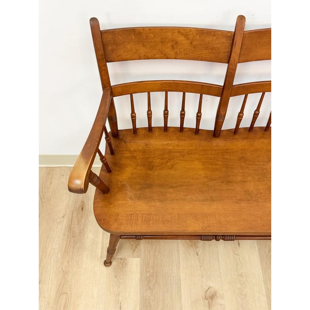 This handsome vintage solid maple spindle two-seat bench is a beautifully crafted and characterful seating find. The warm...