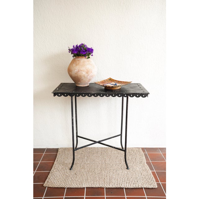 A refined and highly versatile iron garden table featuring a removable tray top and folding base—an elegant example of...